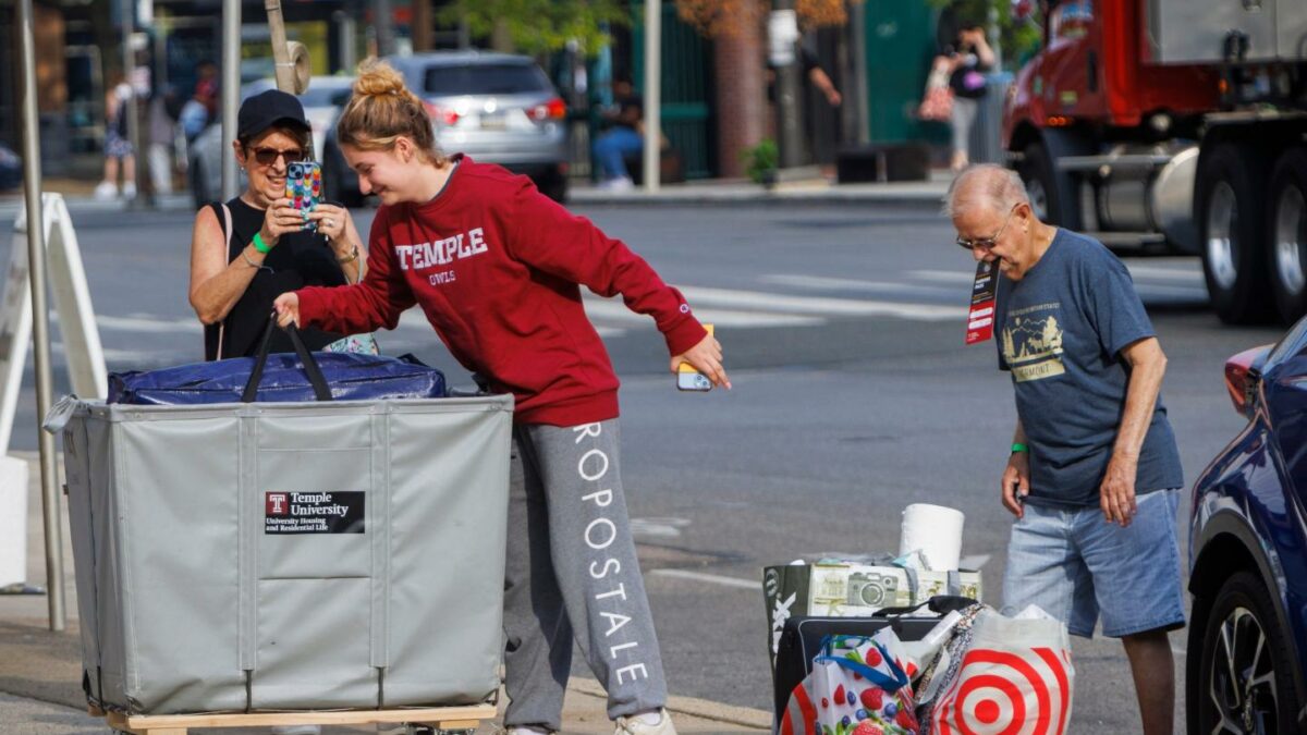 Emily Danenhower, 17, loads her container as grandparents Rena Ruben and Walter McClain help move her into college as students moved into their dorms during move-in-day at Temple University in Philadelphia, on Monday, Aug. 21, 2023.