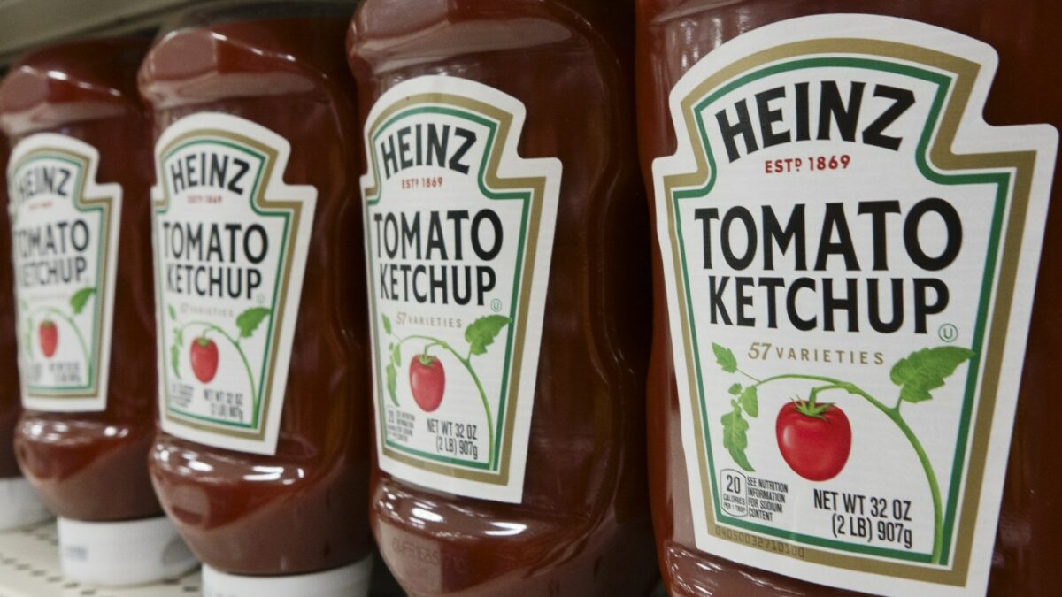 Bottles of Heinz tomato ketchup for sale are displayed at a store