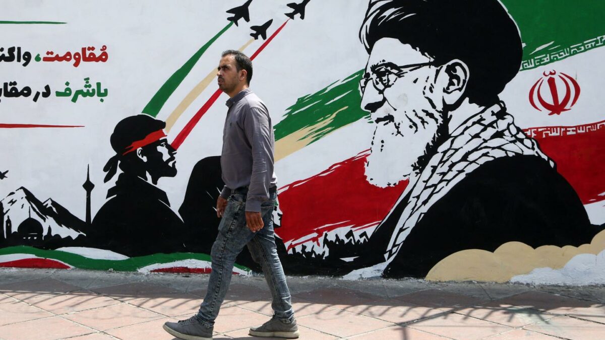 A man walks in front of a wall mural in Tehran, Iran, on August 6, 2026.